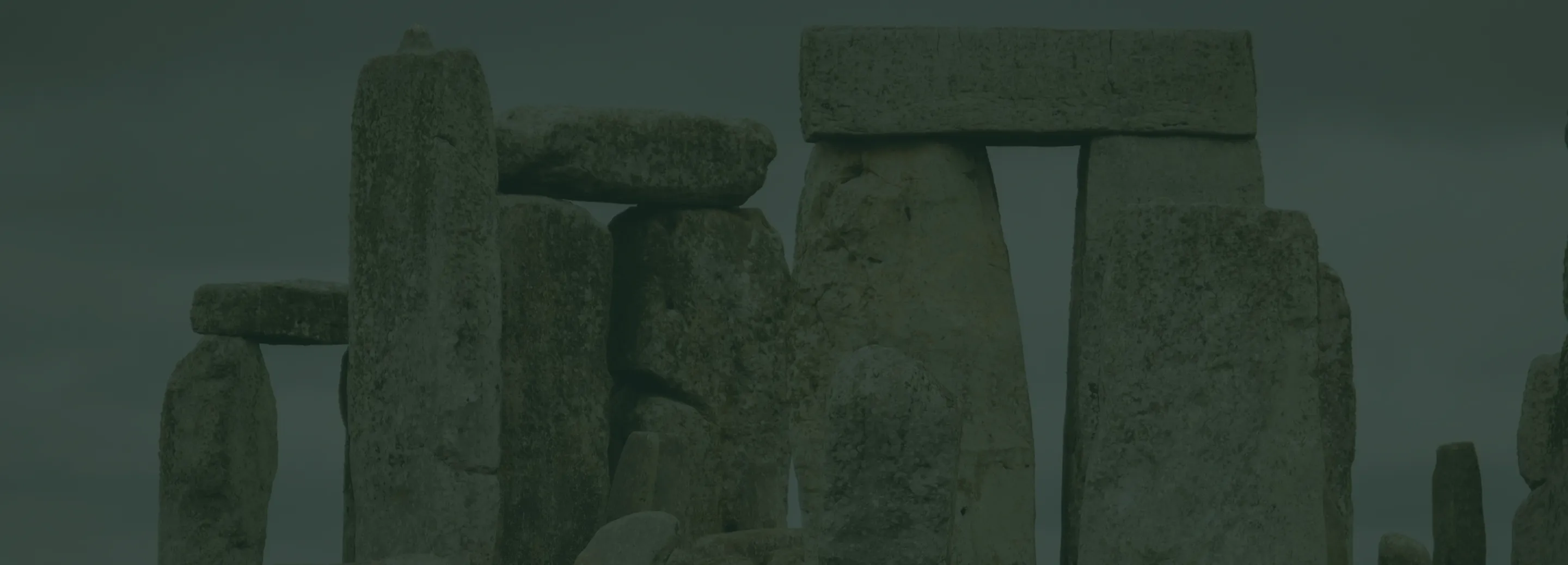 Close-up of Stonehenge prehistoric standing stones under a cloudy sky.