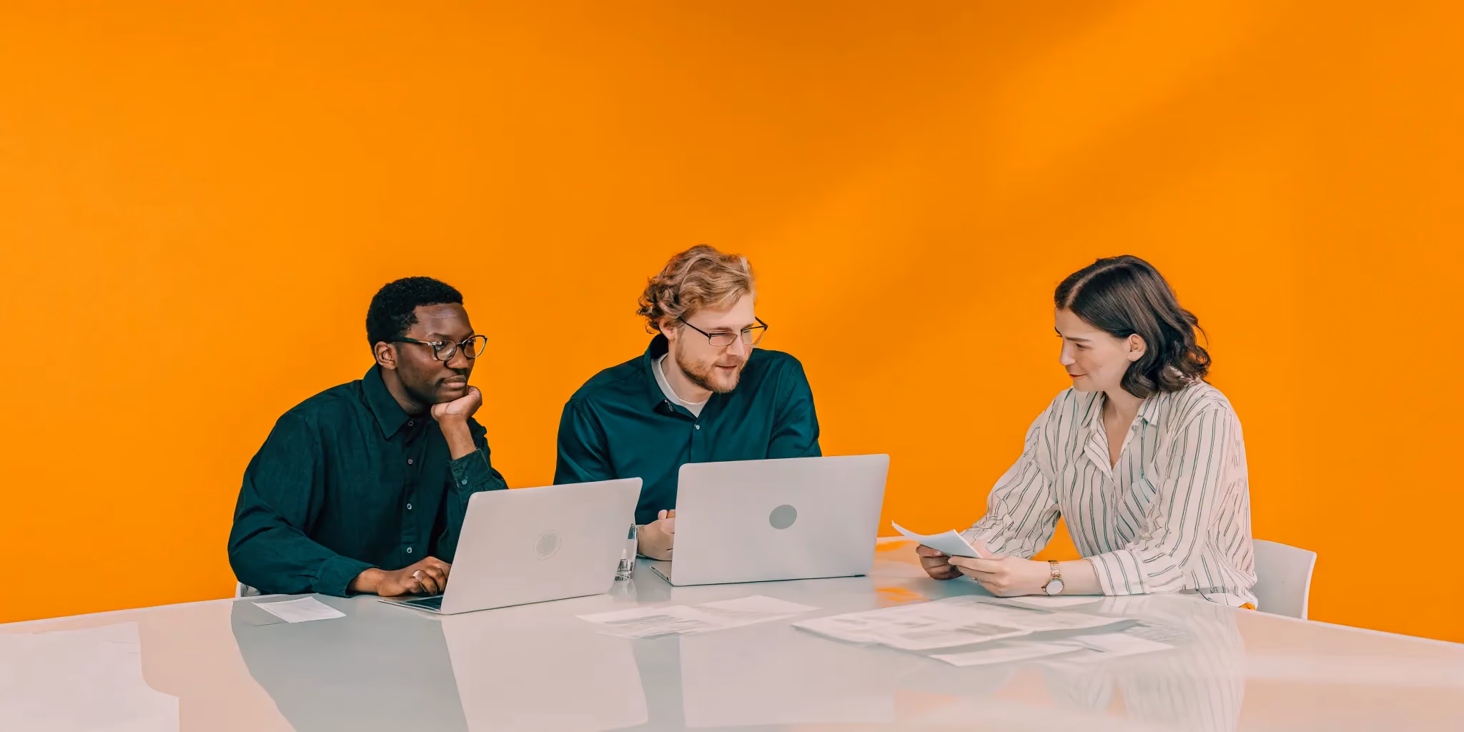 Professional project management team collaborating around a table in a modern office