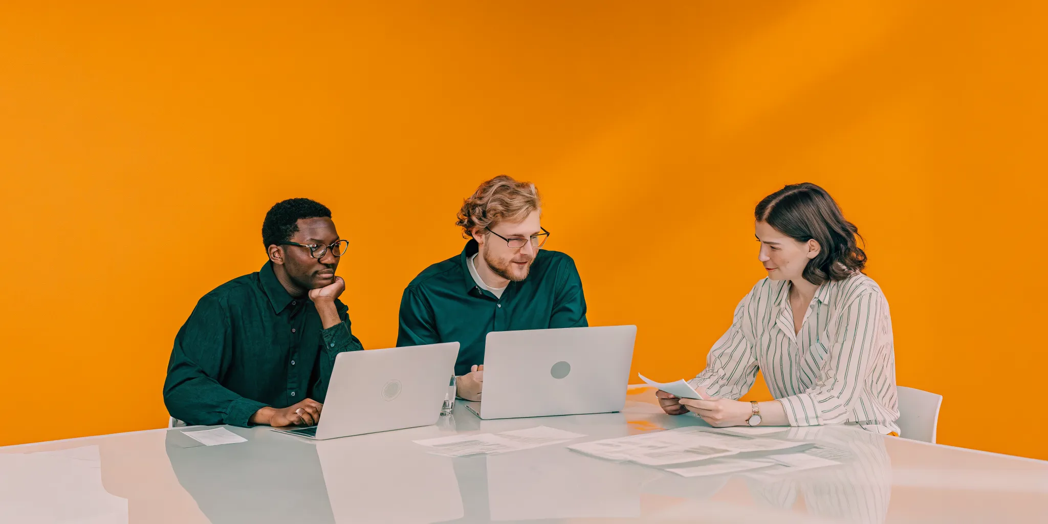 Professional project management team collaborating around a table in a modern office