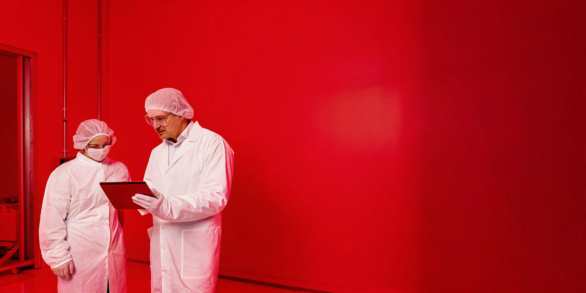 Quality and compliance specialists reviewing a validation checklist in a regulated laboratory