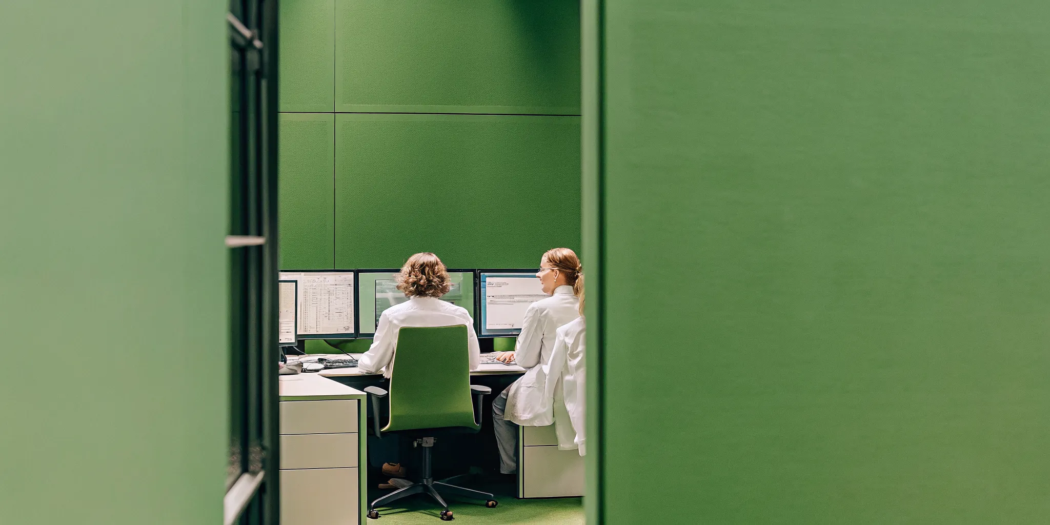 Pharmaceutical clinical trial management office with project dashboards and regulatory compliance documents