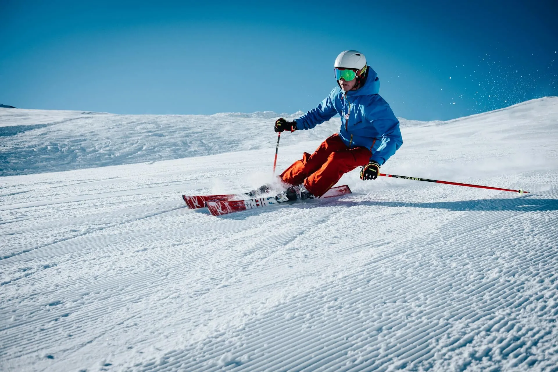 A man skiing down a slope making a turn