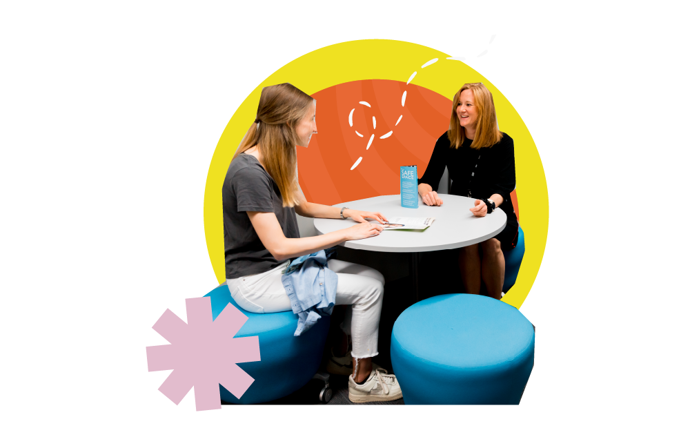 Two people speaking across the table in an appointment