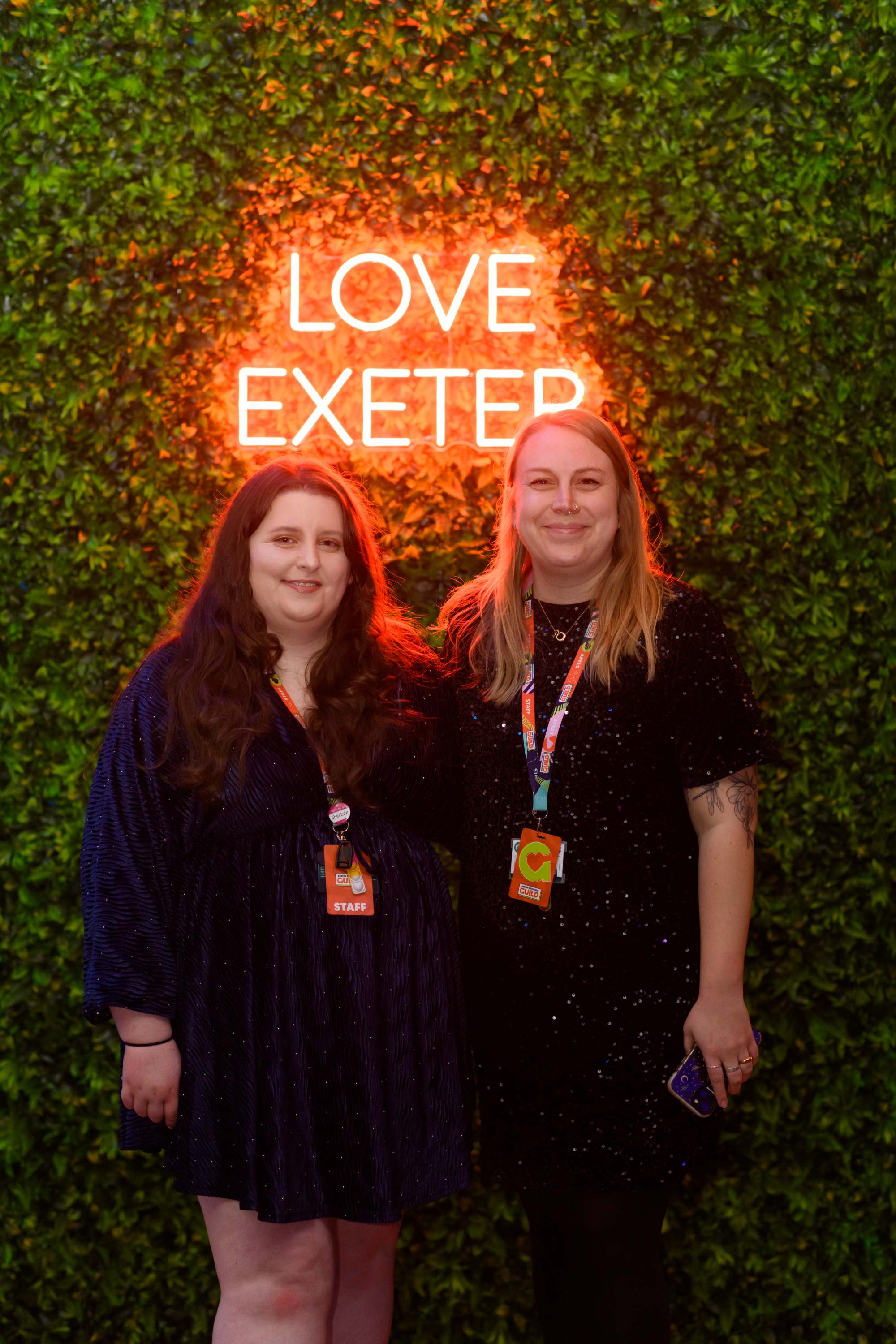 Two women smiling in smart dress at an awards ceremony