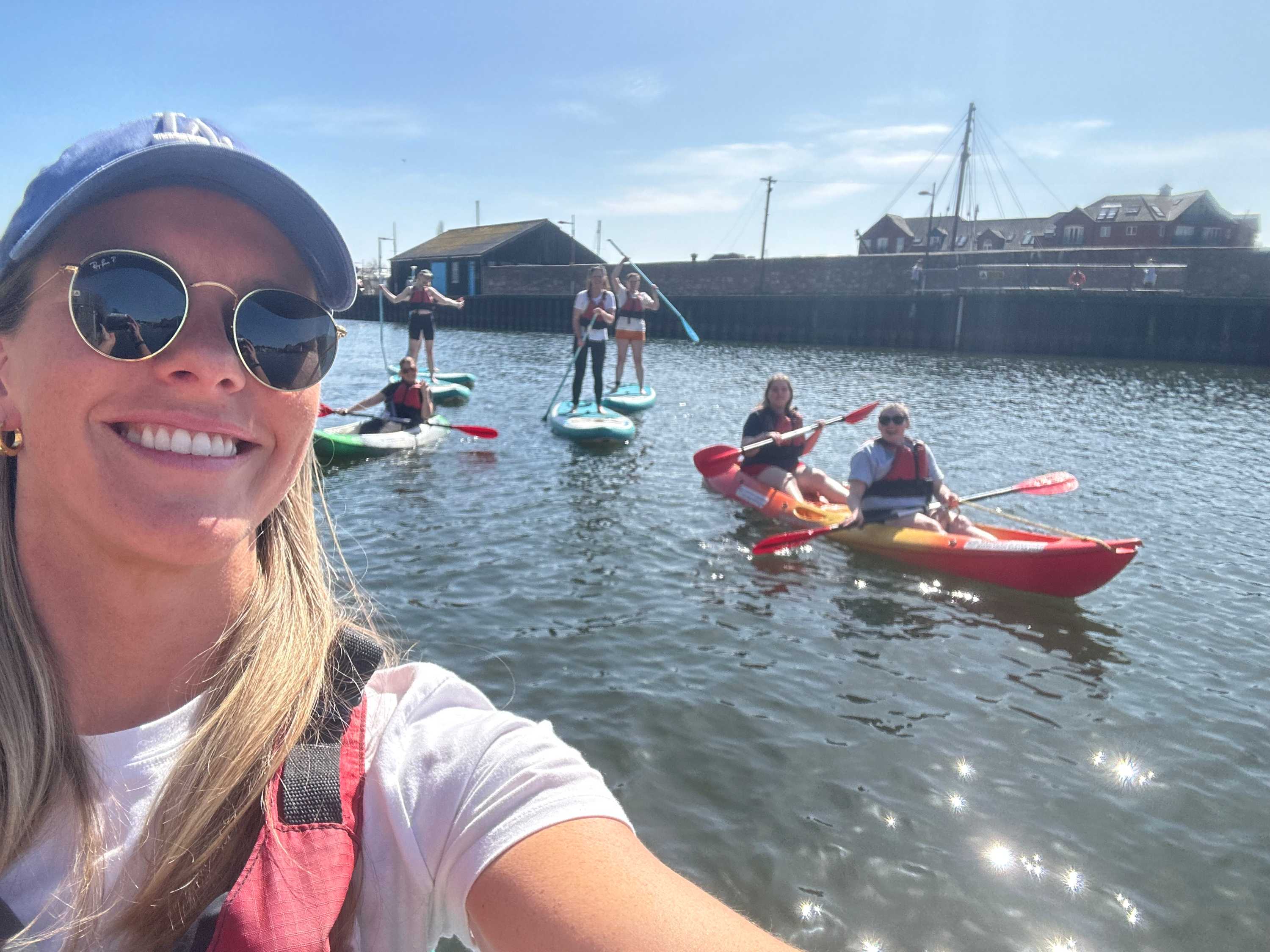 Group of staff kayacking on Exeter Quay