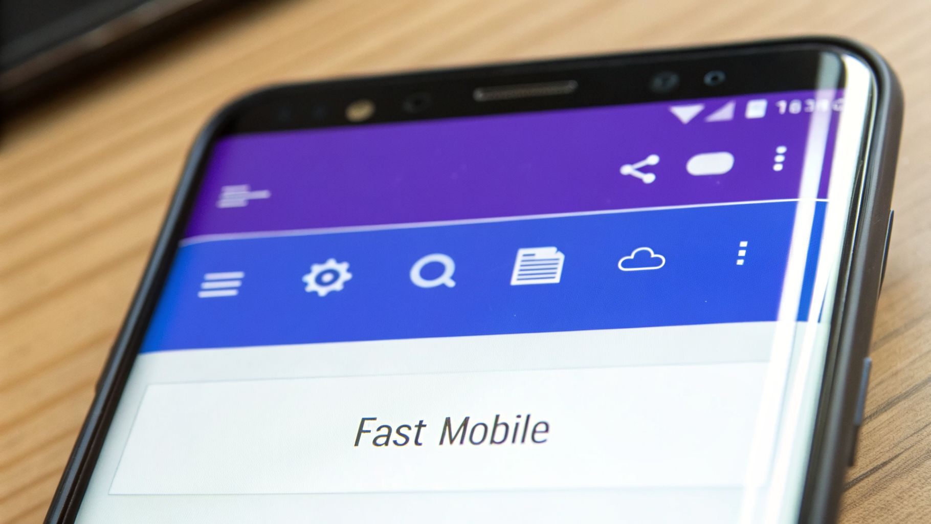 A black smartphone displaying a mobile app interface with 'Fast Mobile' text and navigation icons.