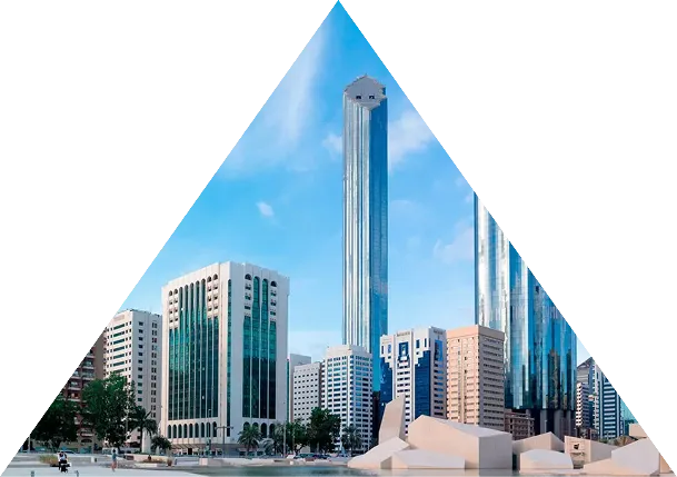 Modern city skyline with tall glass skyscrapers under a blue sky, framed within a triangular shape.