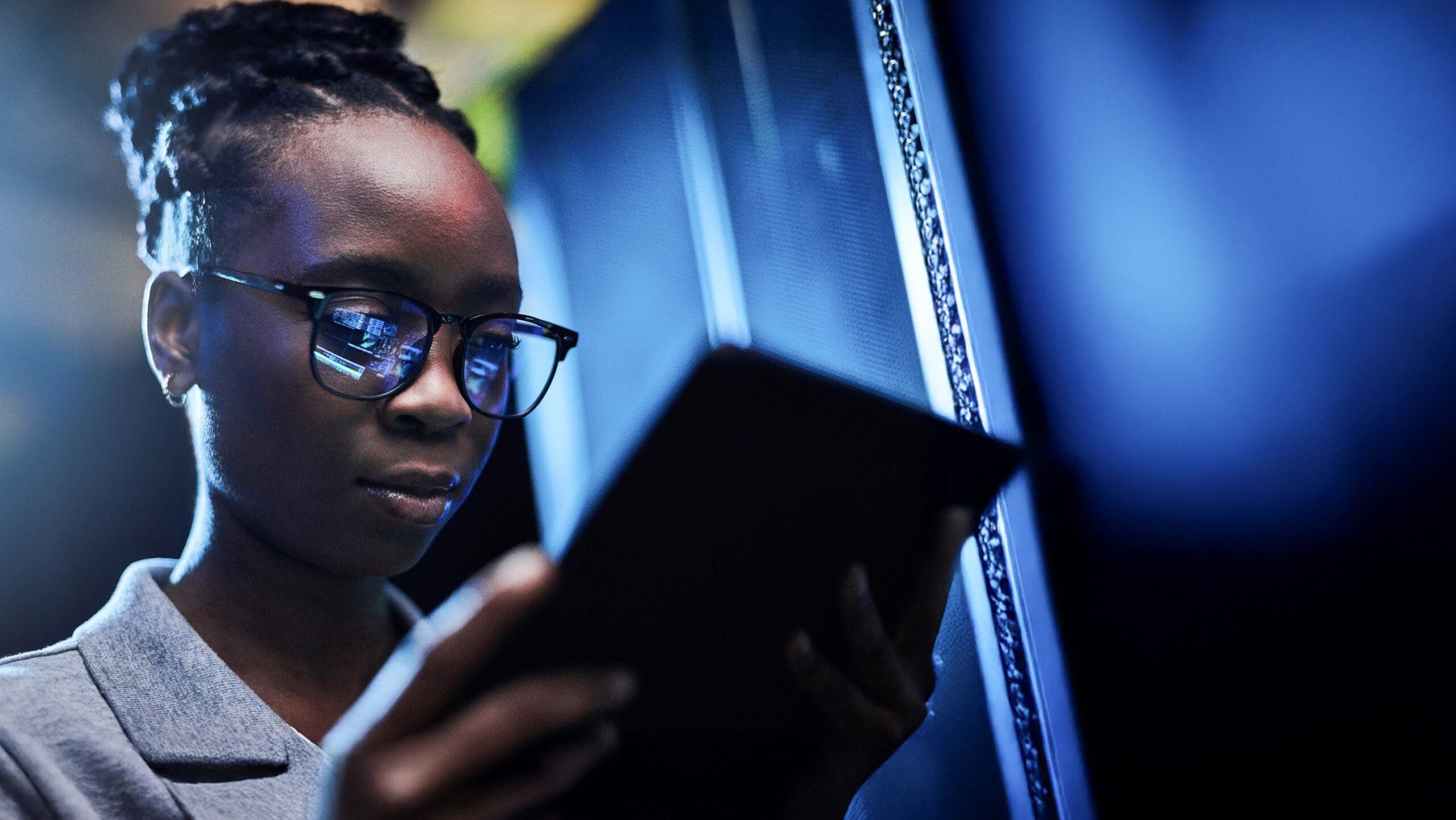 woman looking at tablet in office
