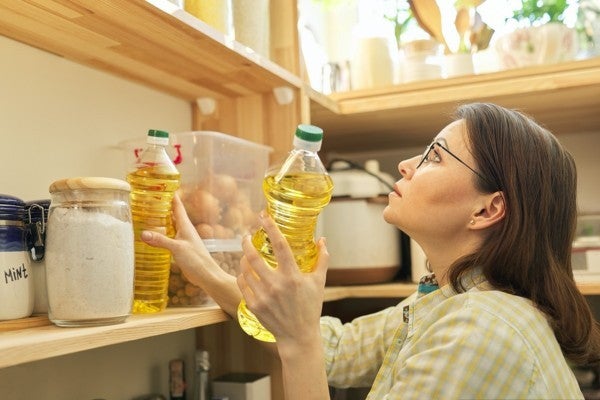 Woman stocking her pantry.
