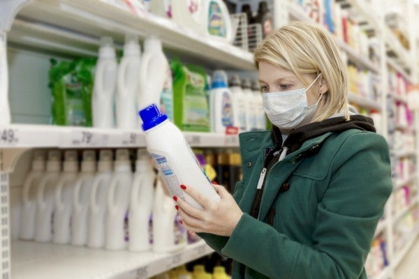 Woman reading a label in a store.