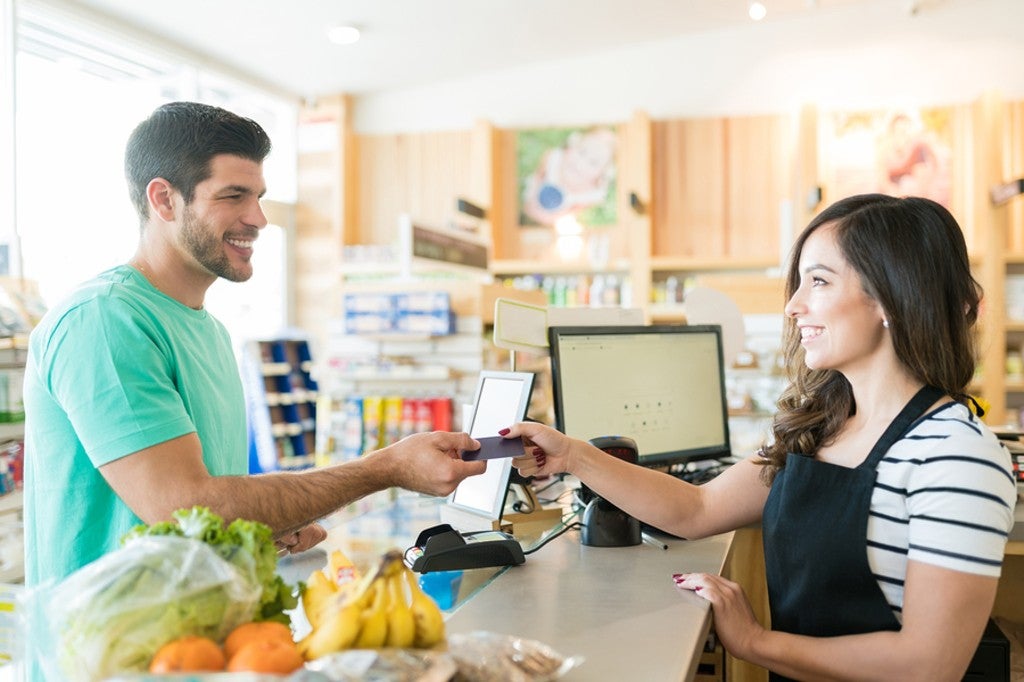 Customer making a purchase in a shop with a credit card.