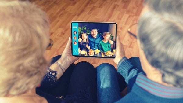 Senior couple in a video conference using a tablet.