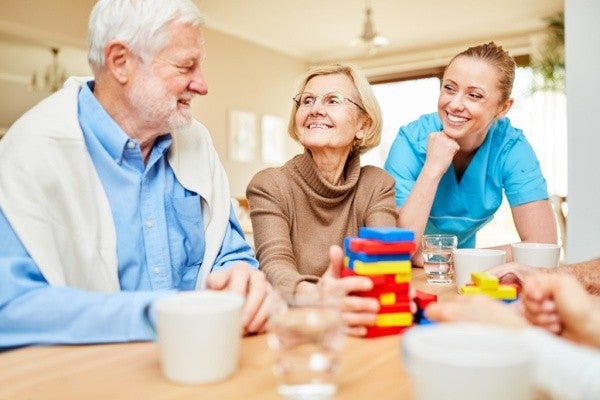 Smiling senior couple with an occupational therapist.