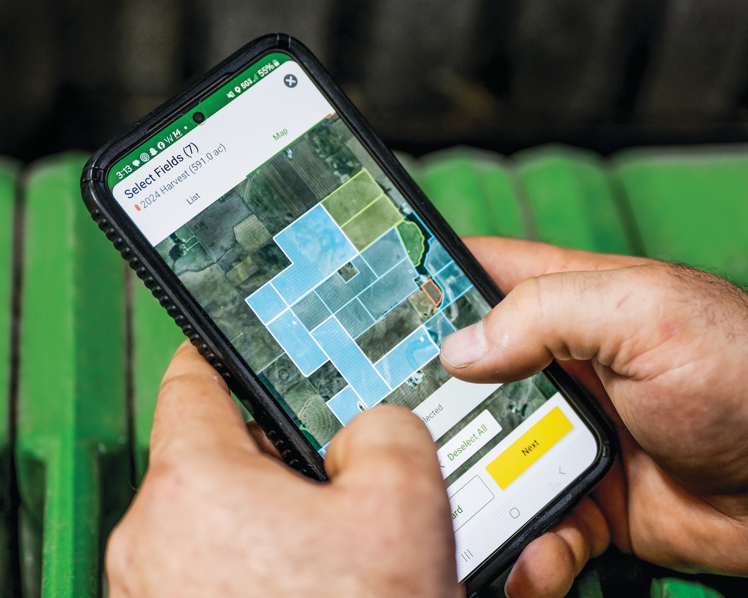 Person utilizing mobile device to access autonomous tillage information in Operations Center.