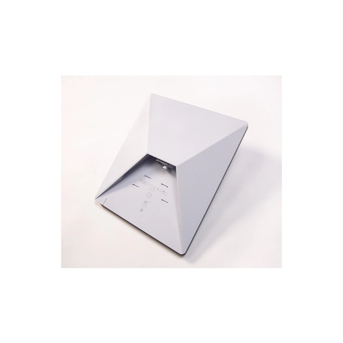 Underside view of a JDLink Boost Mini Terminal showing its textured white housing, mounting surface, and connection area
