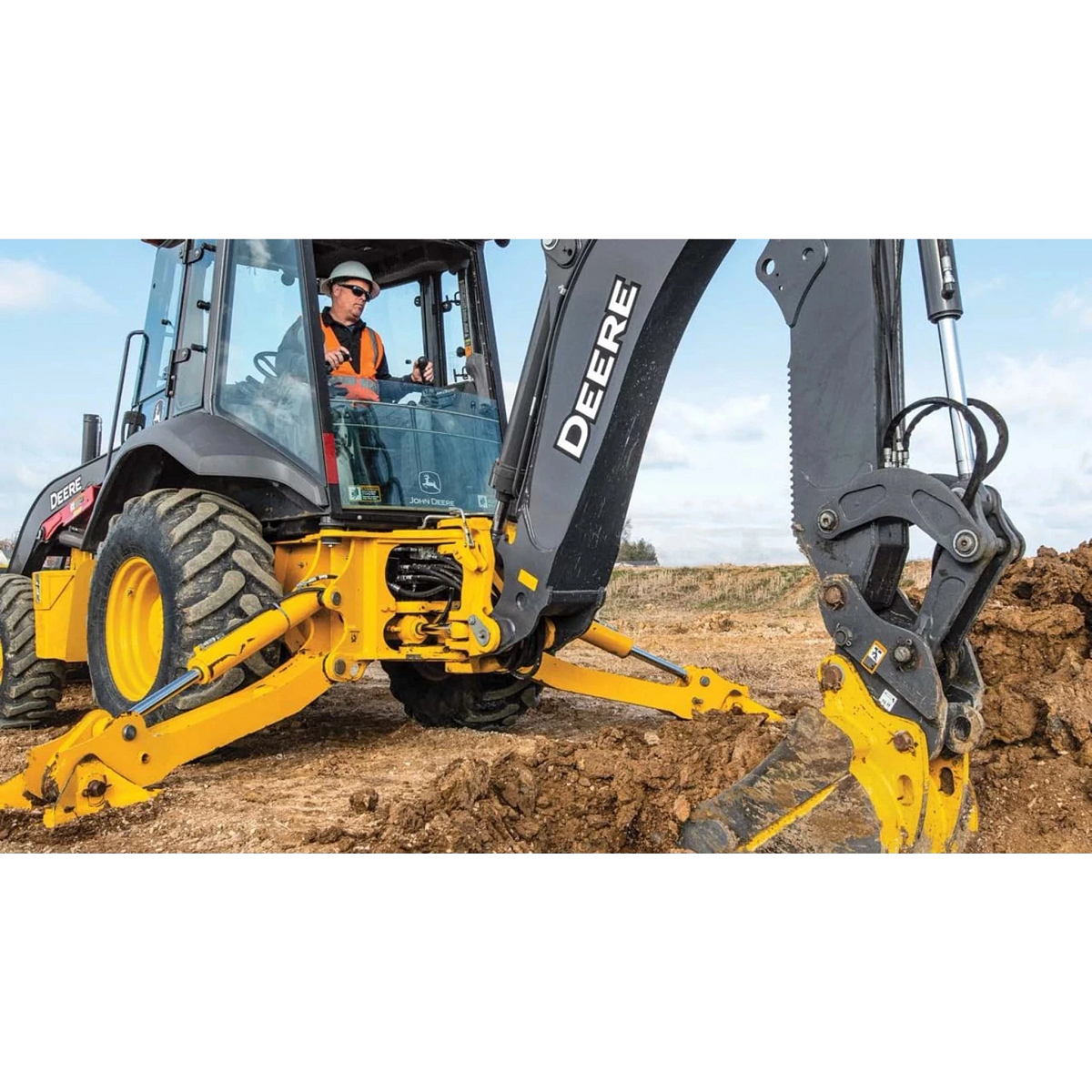 310 P-Tier Backhoe Loader with a close up of a operator digging a hole at a construction site