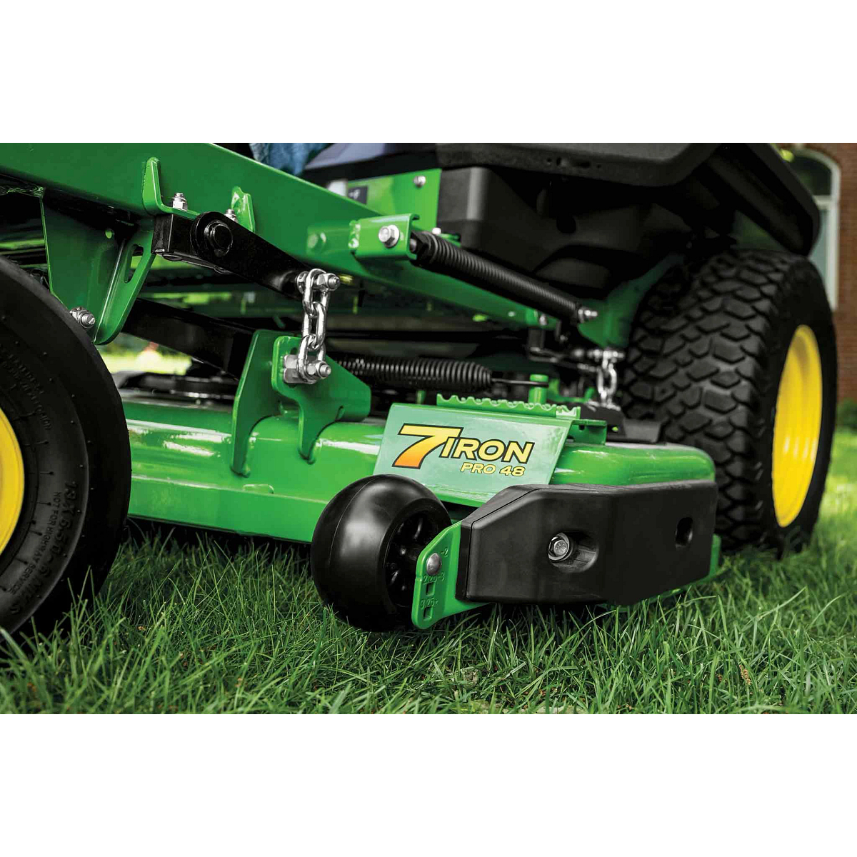 A zoomed-in shot of a green 7Iron PRO 48 inch deck on grass.
