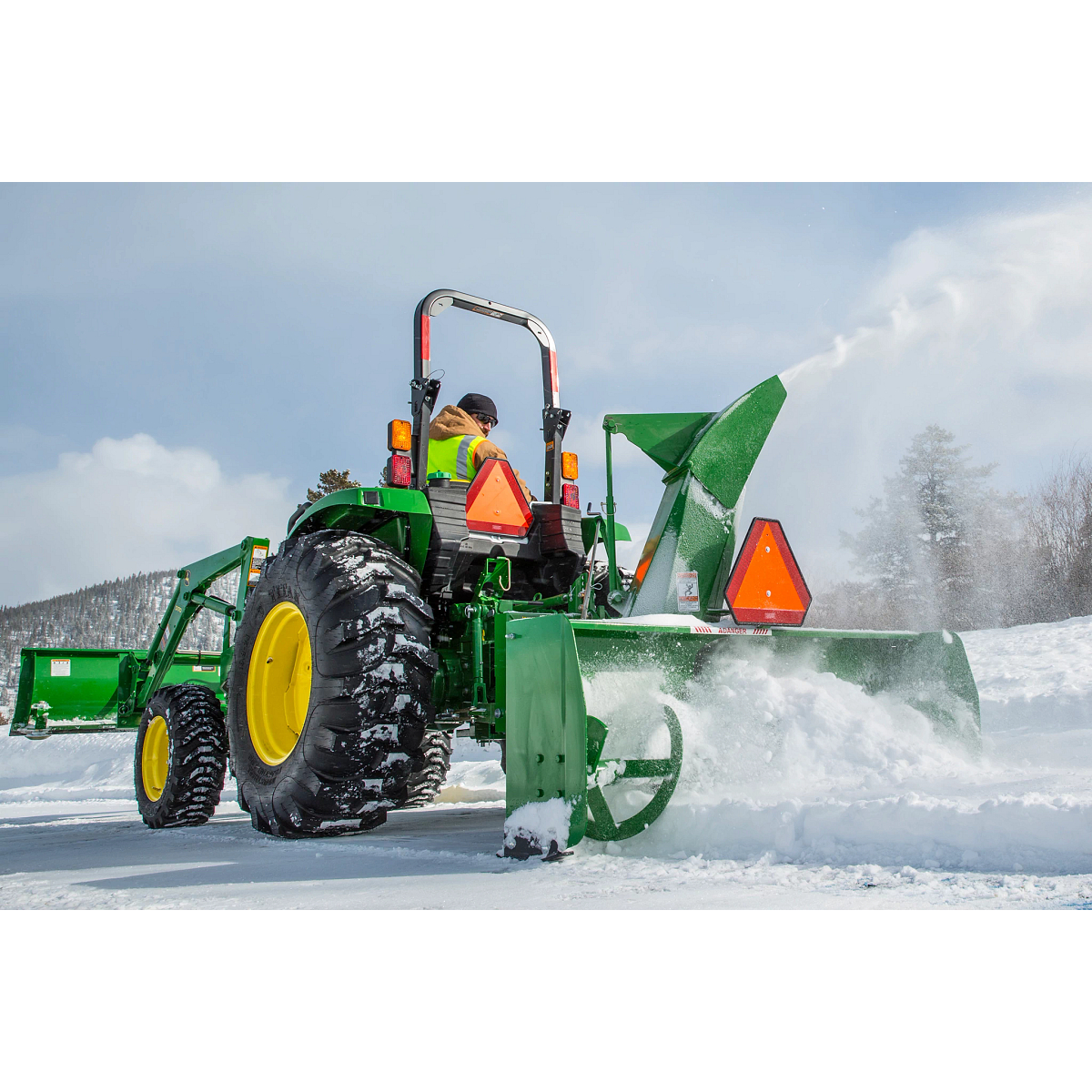 Blowing snow using a SB1174 Snowblower on 4052M Tractor on snowy drive