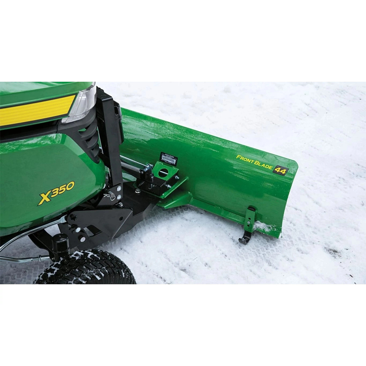 Green 44-in. front blade snow removal attachment installed on the front of a x350 Lawn Tractor in the snow
