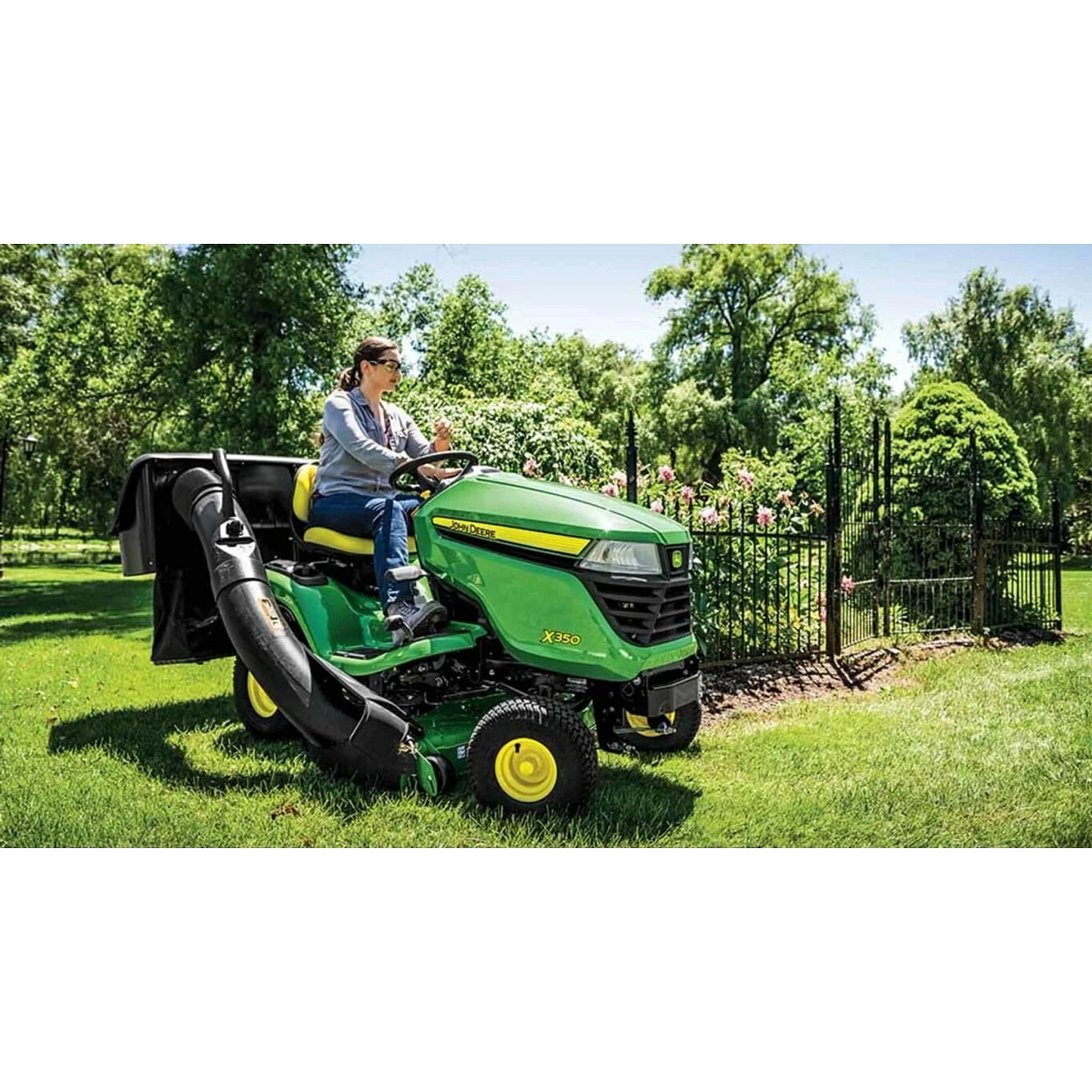 Homeowner driving an X350 Select Series Lawn Tractor with a bagging attachment mowing a yard