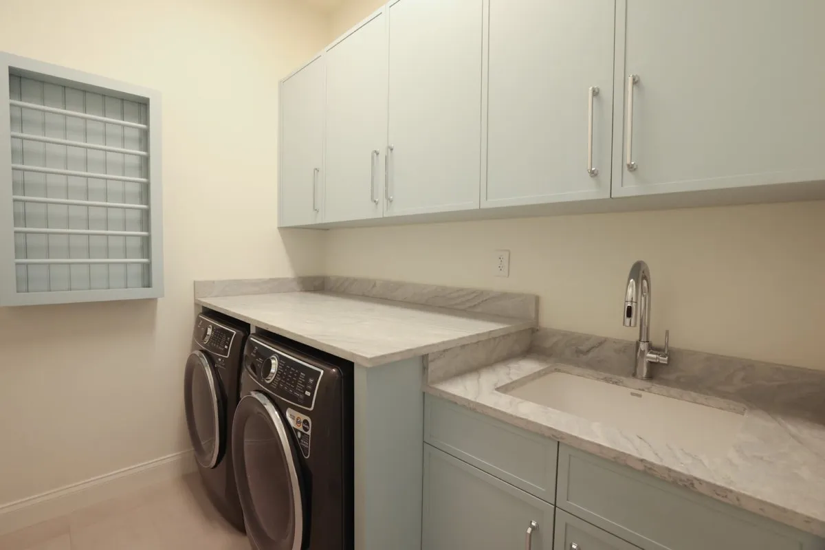 Homeowner preparing space for custom cabinet installation with tools and design plans