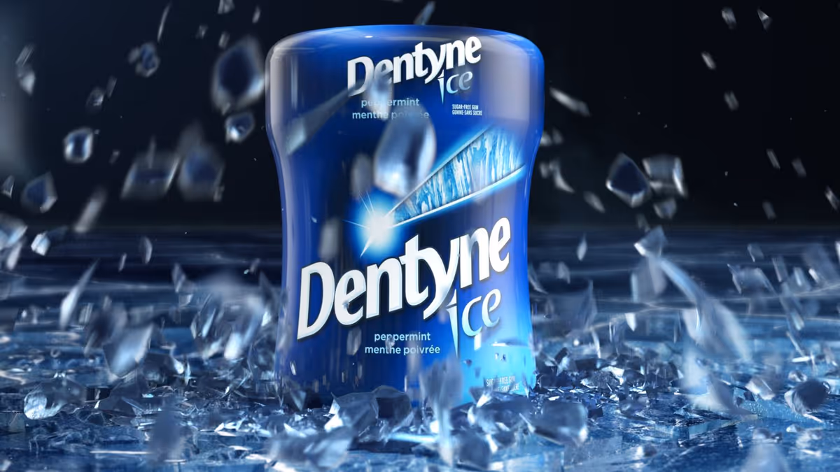 Blue container of Dentyne Ice peppermint sugar-free gum surrounded by shards of ice.