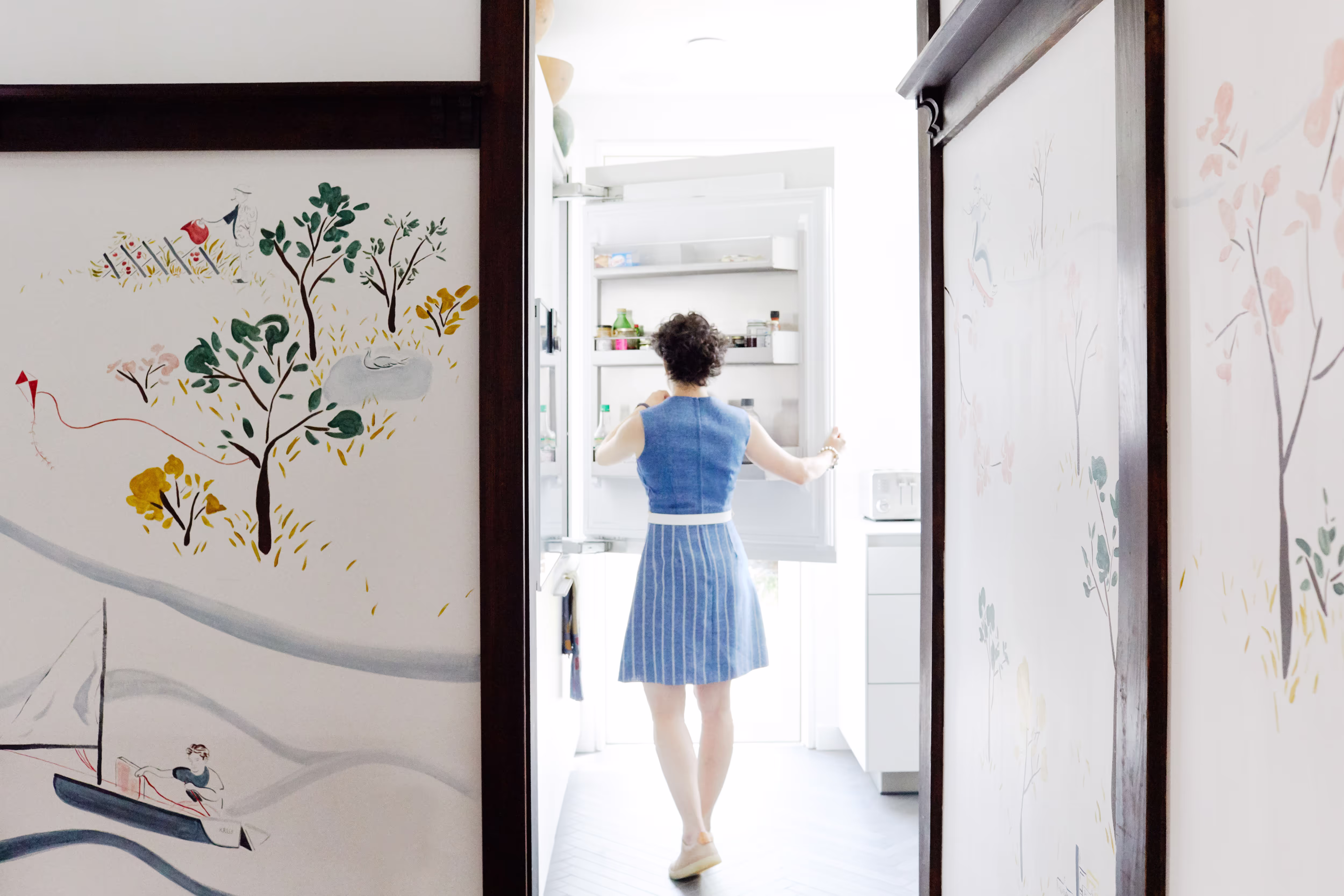 woman standing in doorway interior photography