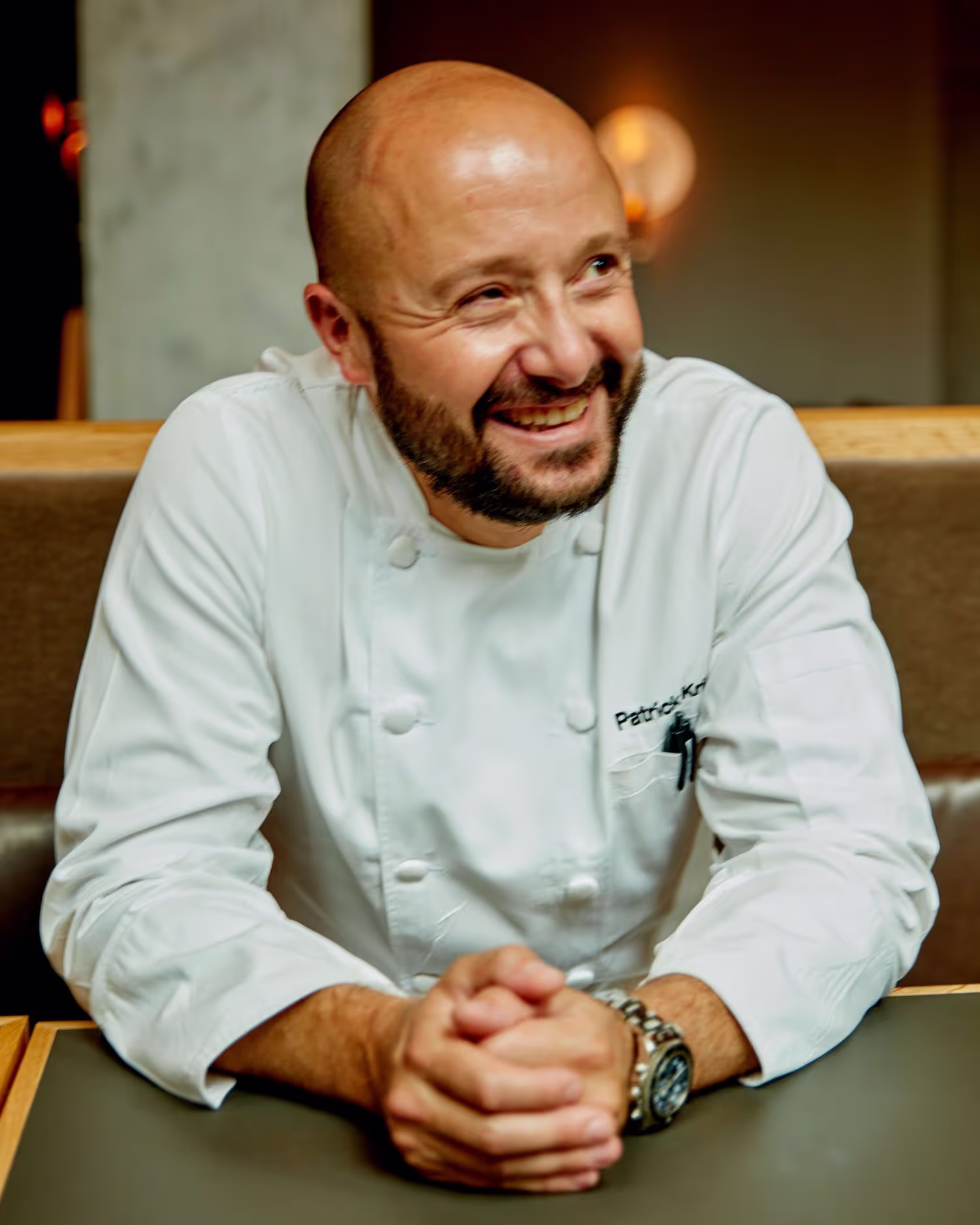 Lifestyle portrait photography of a chef under strobe lighting in a restaurant captured by toronto commercial photographer