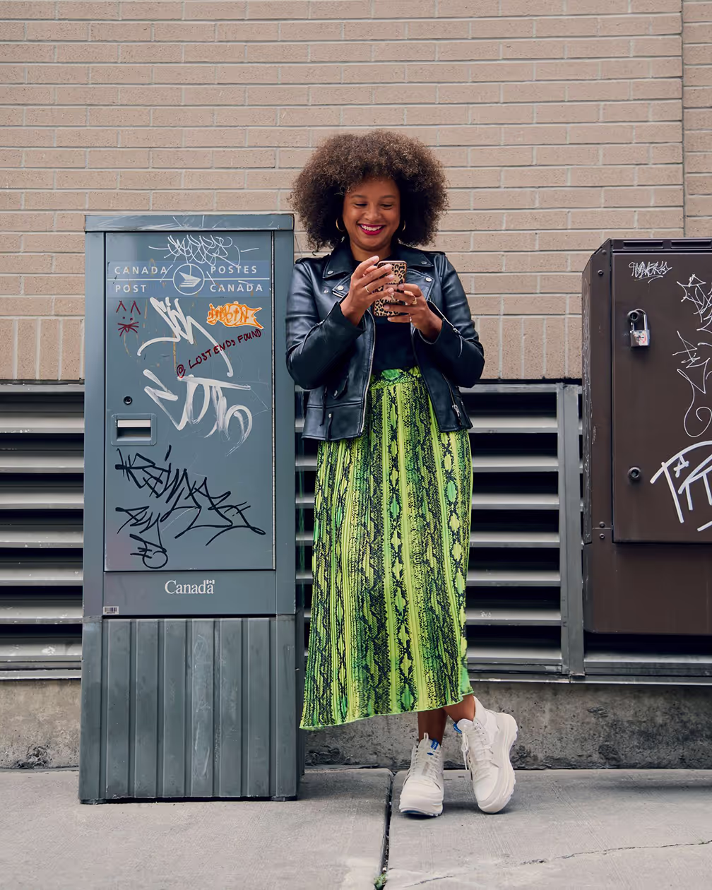 black woman in skirt standing outside shot for editorial campaign by photographer