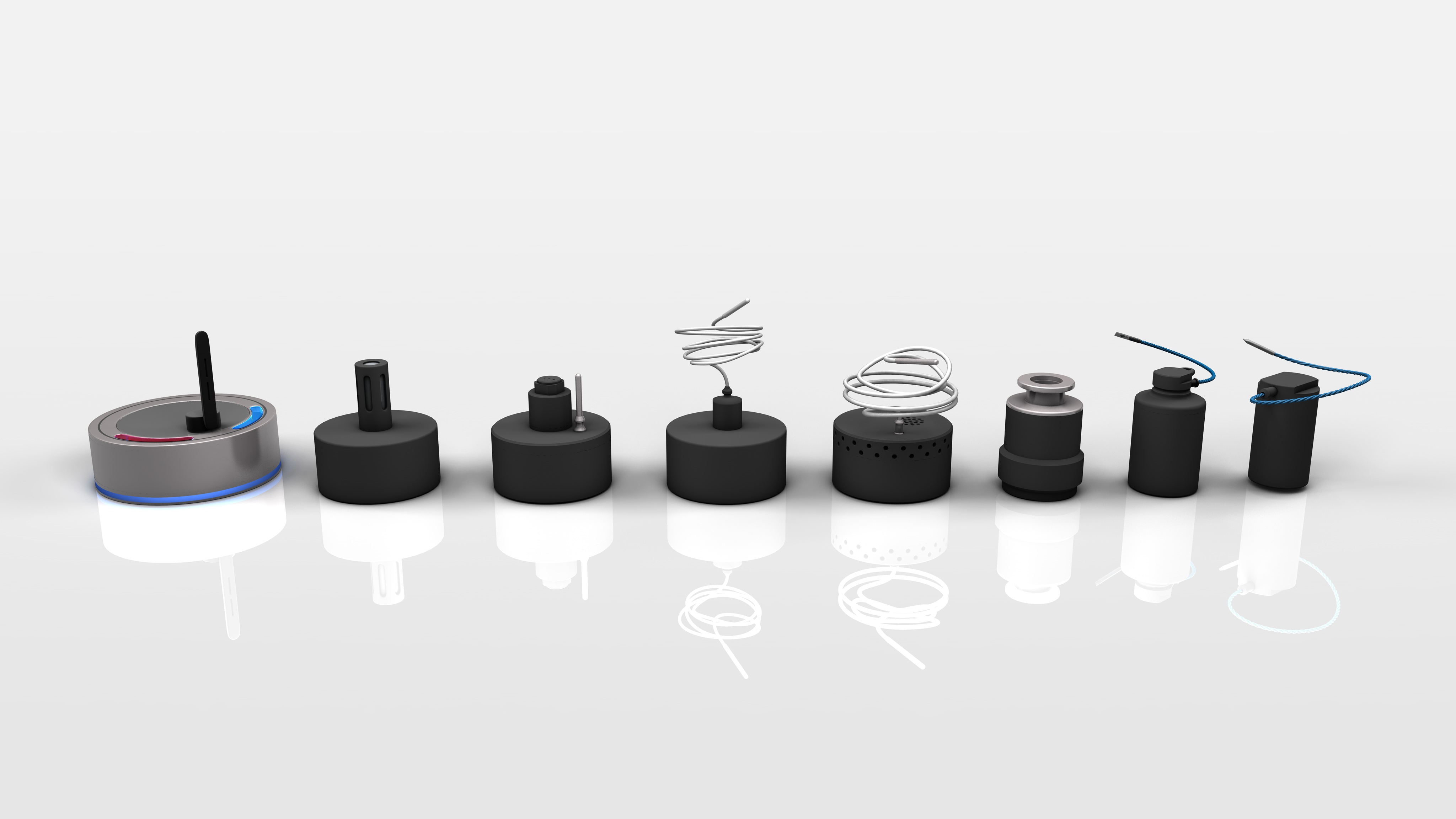 A row of eight different black and grey electronic sensor devices with varied antenna and connector designs on a reflective white surface.
