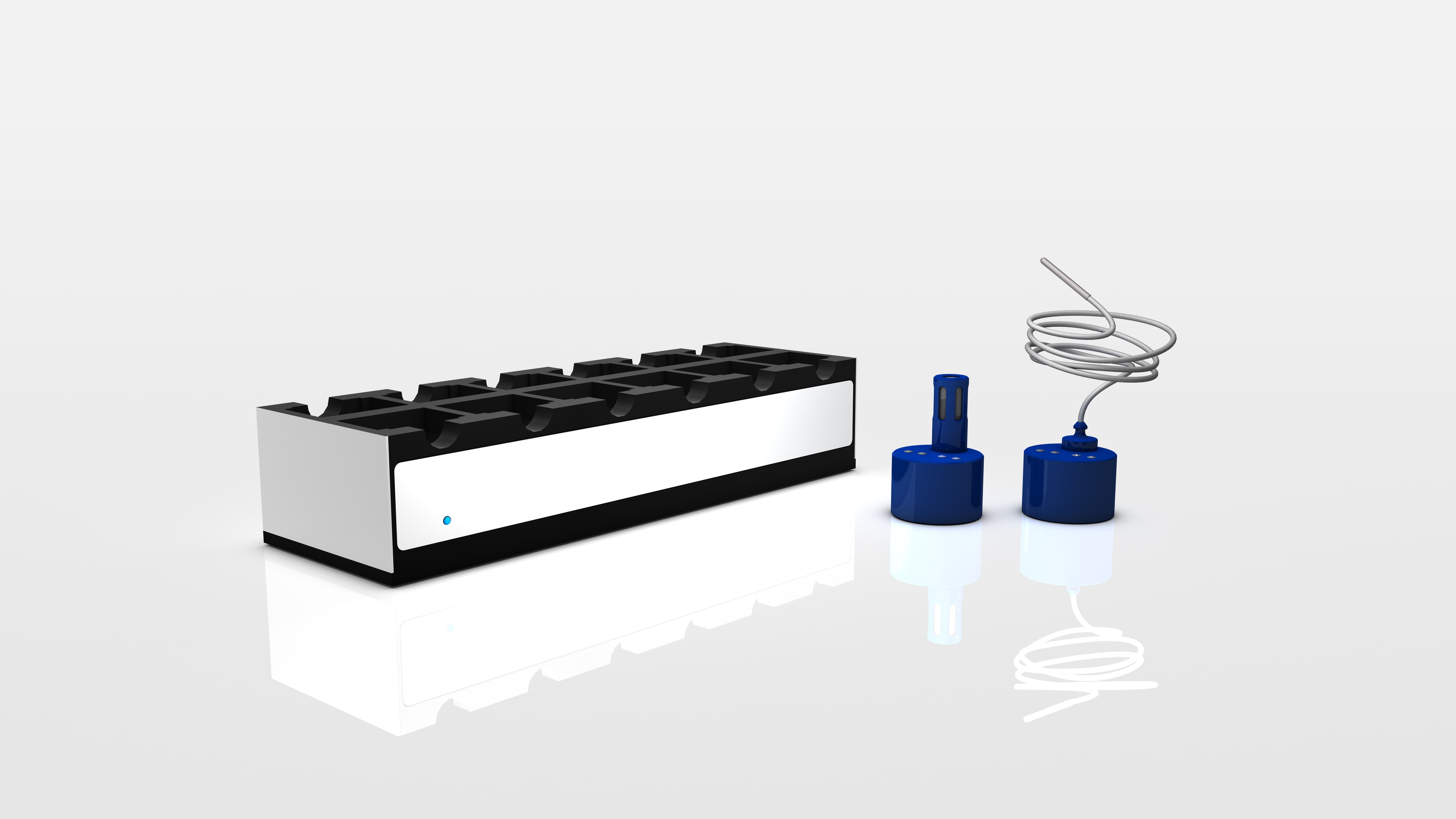 Electronic docking station with eight slots next to two small blue devices, one with a coiled wire attached.