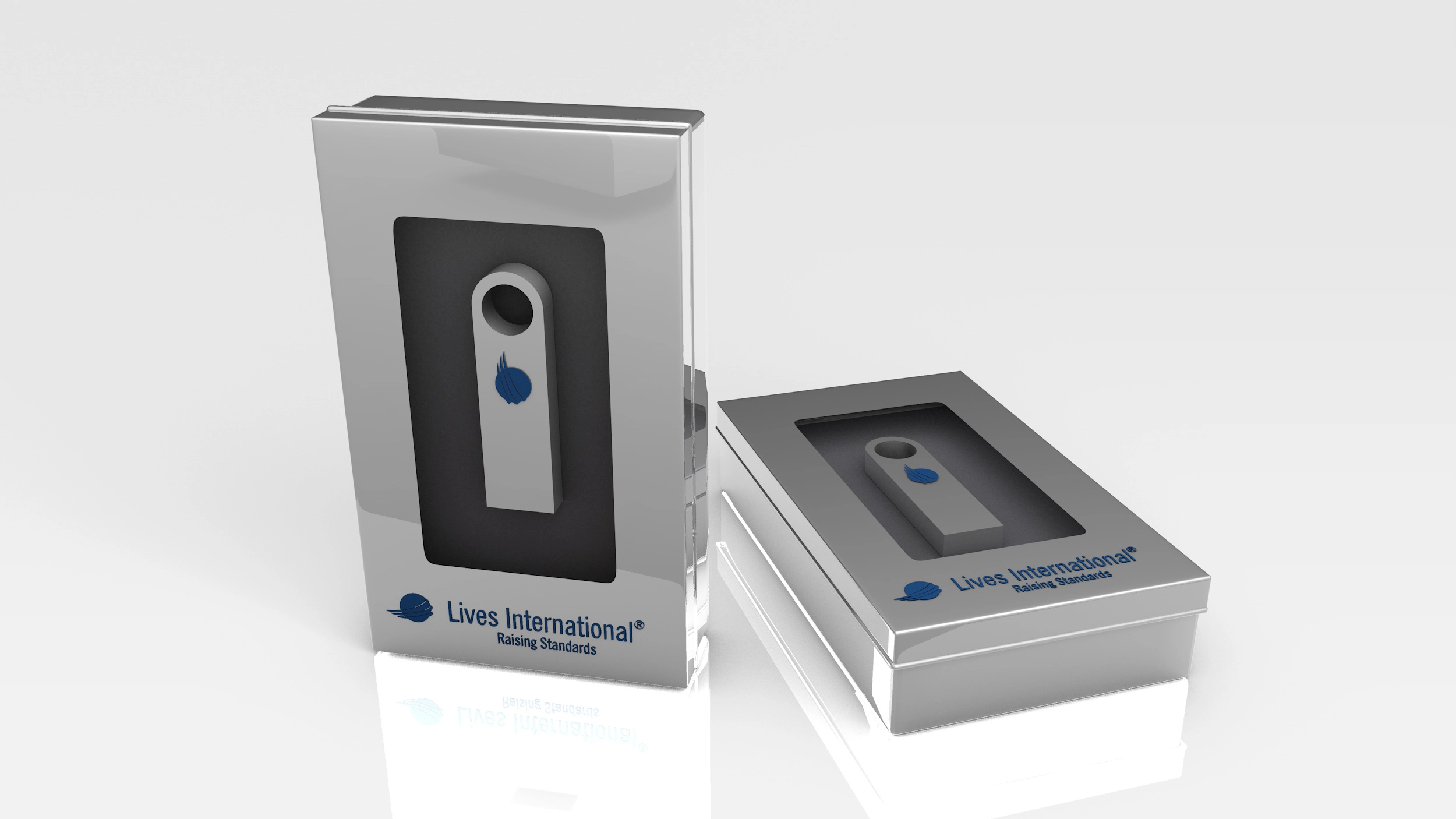 Two shiny silver rectangular boxes with clear lids displaying a small device inside, labeled 'Lives International Raising Standards'.