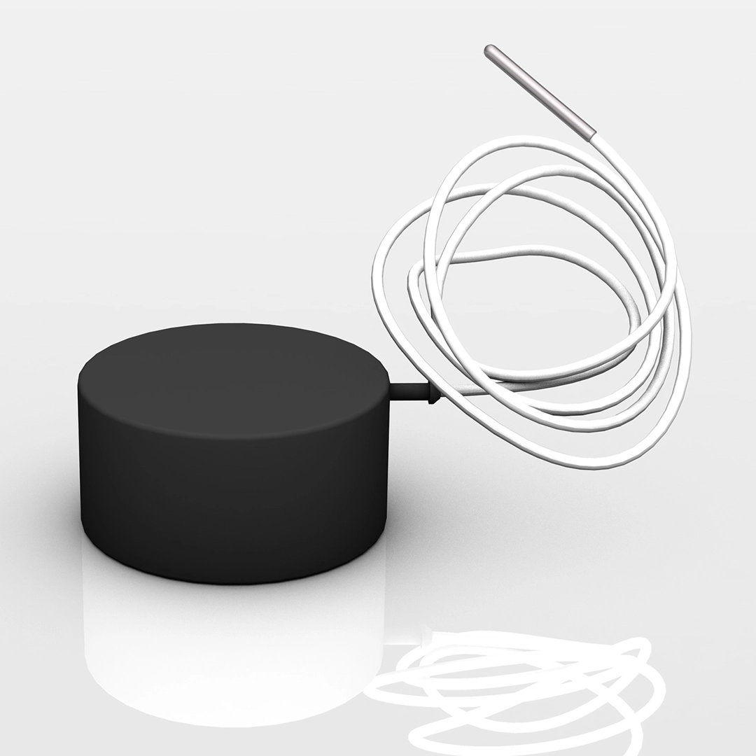 Black round device with a coiled white cord and a metallic tip on a reflective surface.