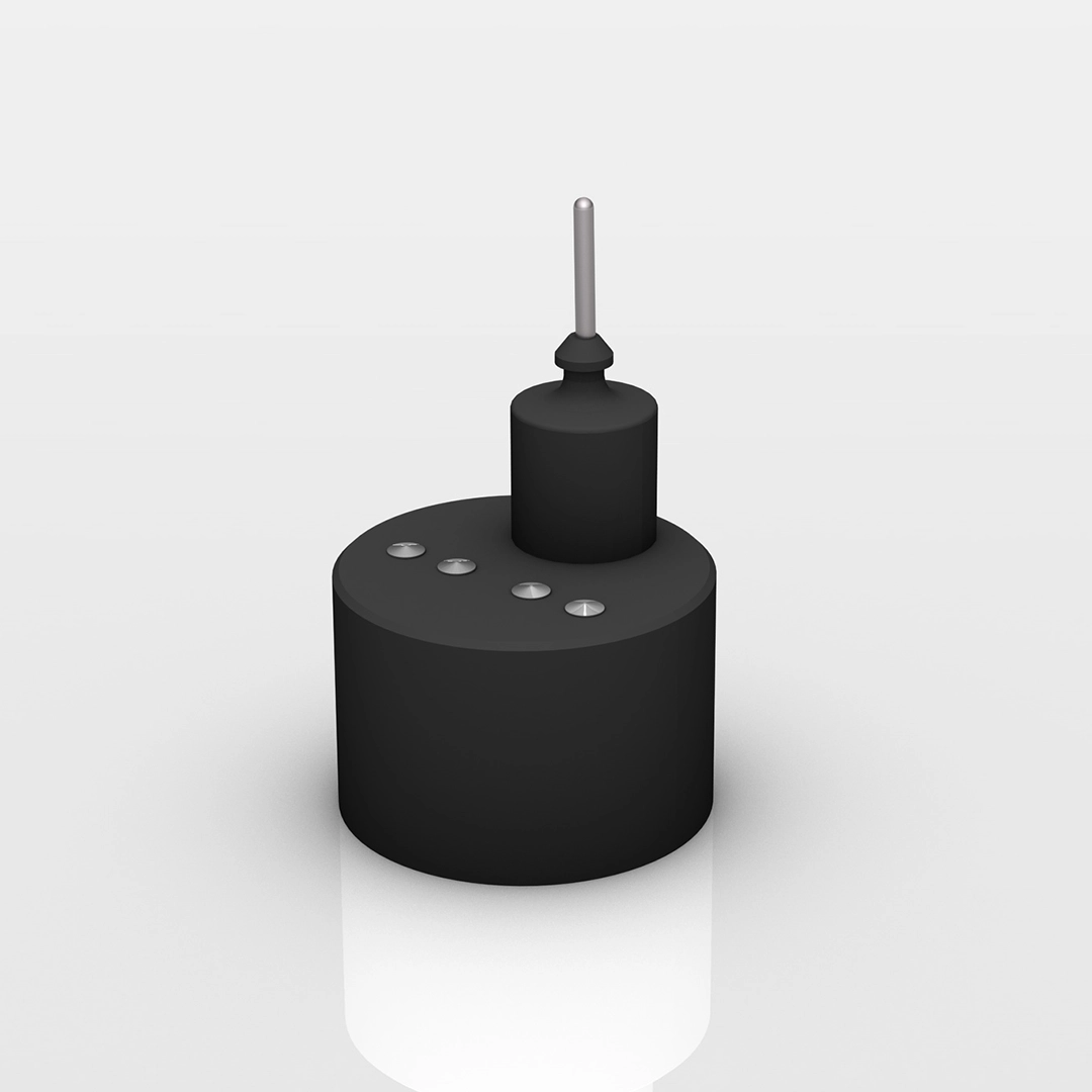 Black cylindrical device with four metallic buttons on top and a small vertical antenna-like rod.