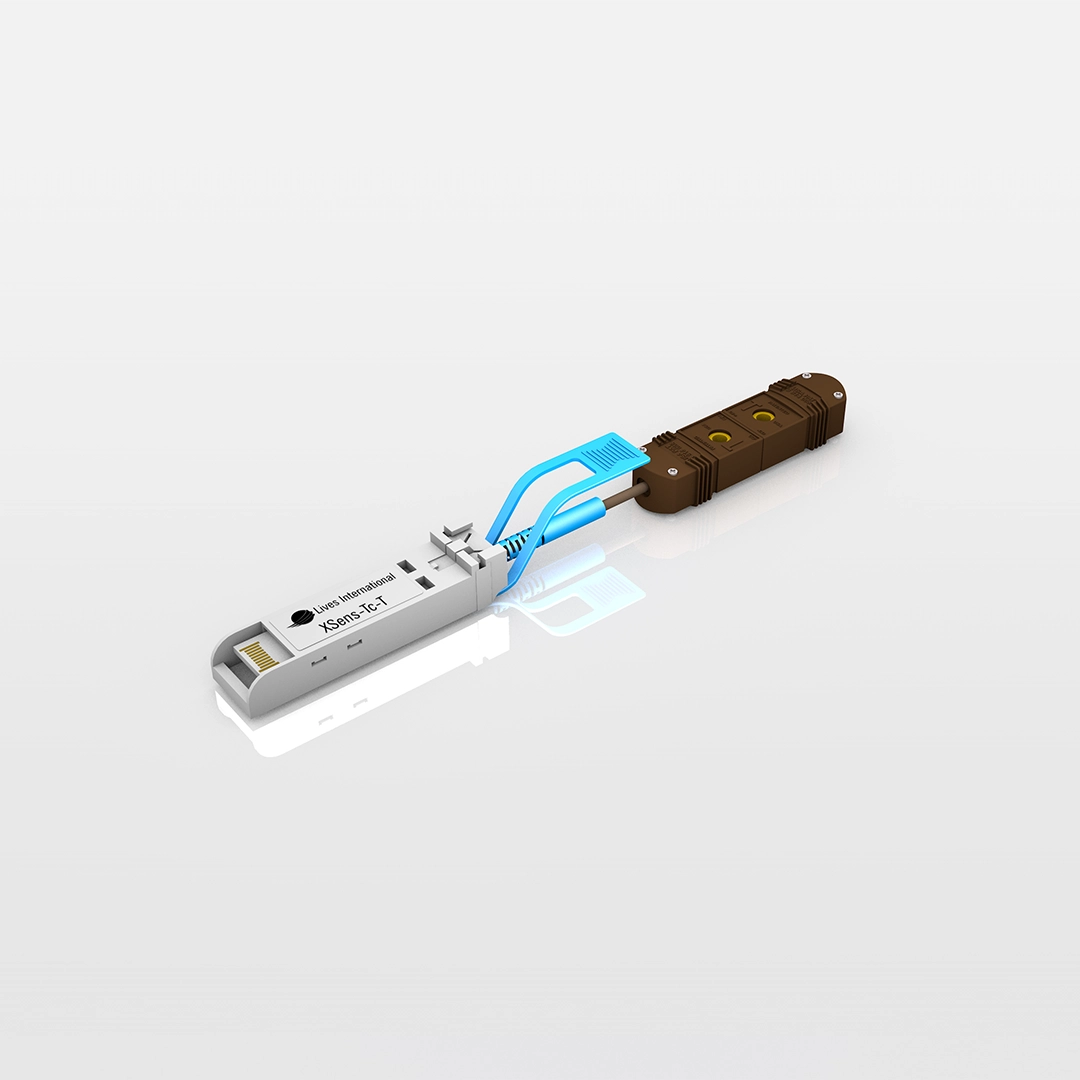 Close-up of a white Xsens-Tc-T device with blue latch clips connected to a brown cable connector on a reflective surface.