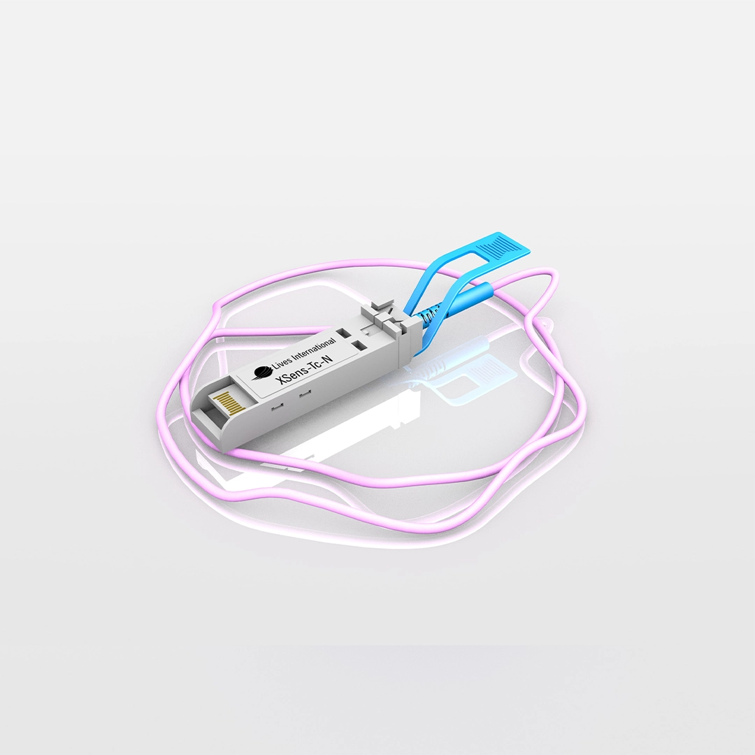 XSens-TC-N device with a coiled pink cable and blue latch on a reflective white surface.