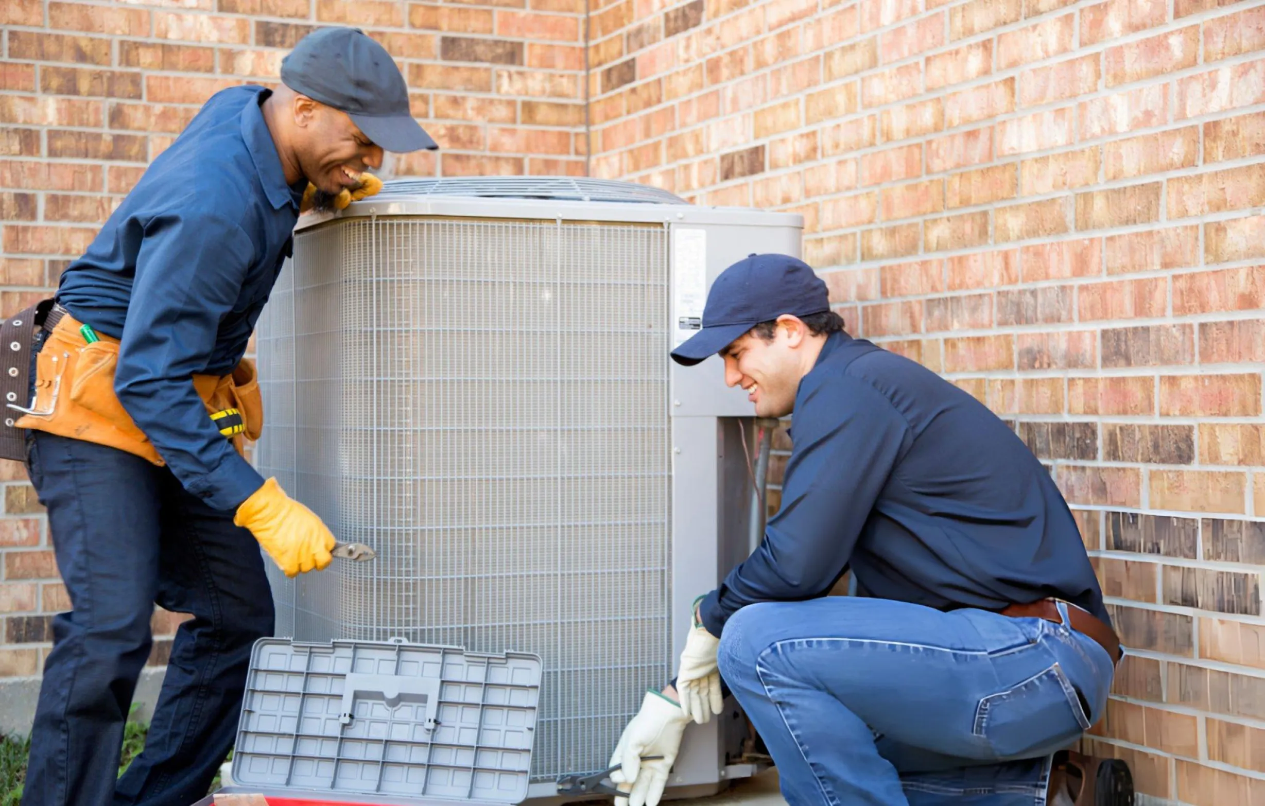 Technician checking HVAC filters and components during a routine maintenance visit