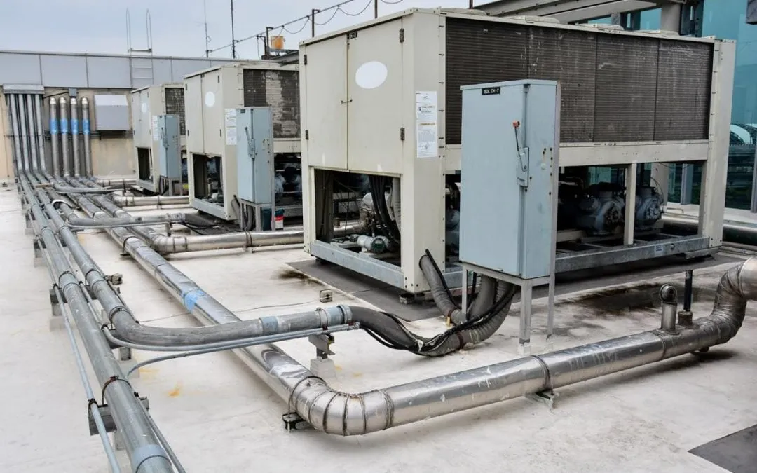 Commercial rooftop HVAC equipment connected with metal piping