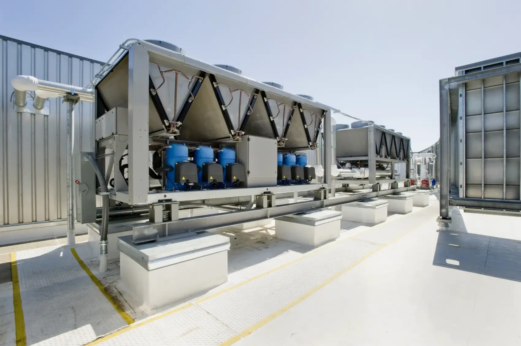 Large commercial rooftop HVAC installation with multiple cooling units