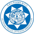 A circular logo with a star design in blue, featuring the text 'Sacramento Veteran Police Officers Association' around the border, and a central illustration representing community and law enforcement.