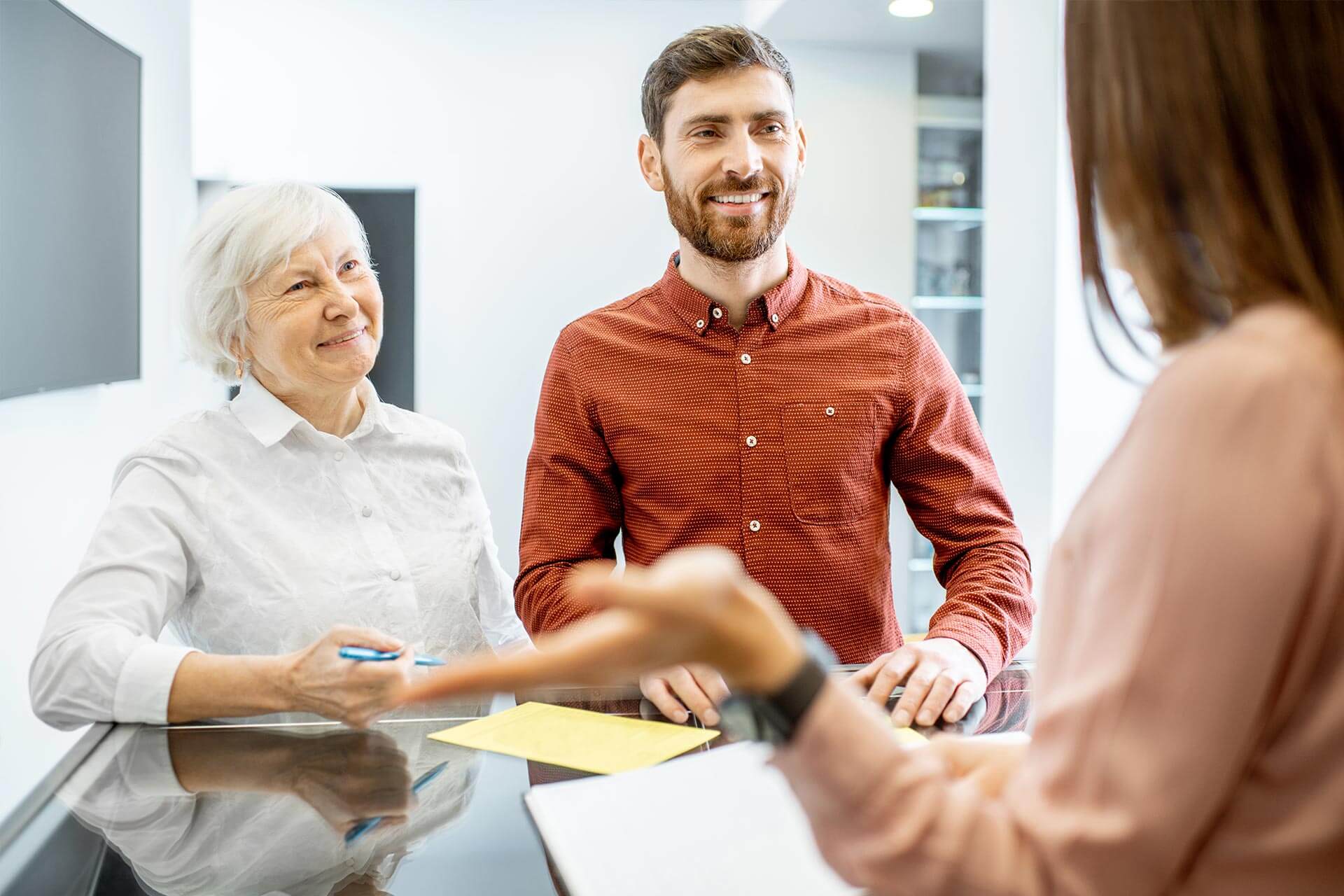 A man shaking hands with an older woman.