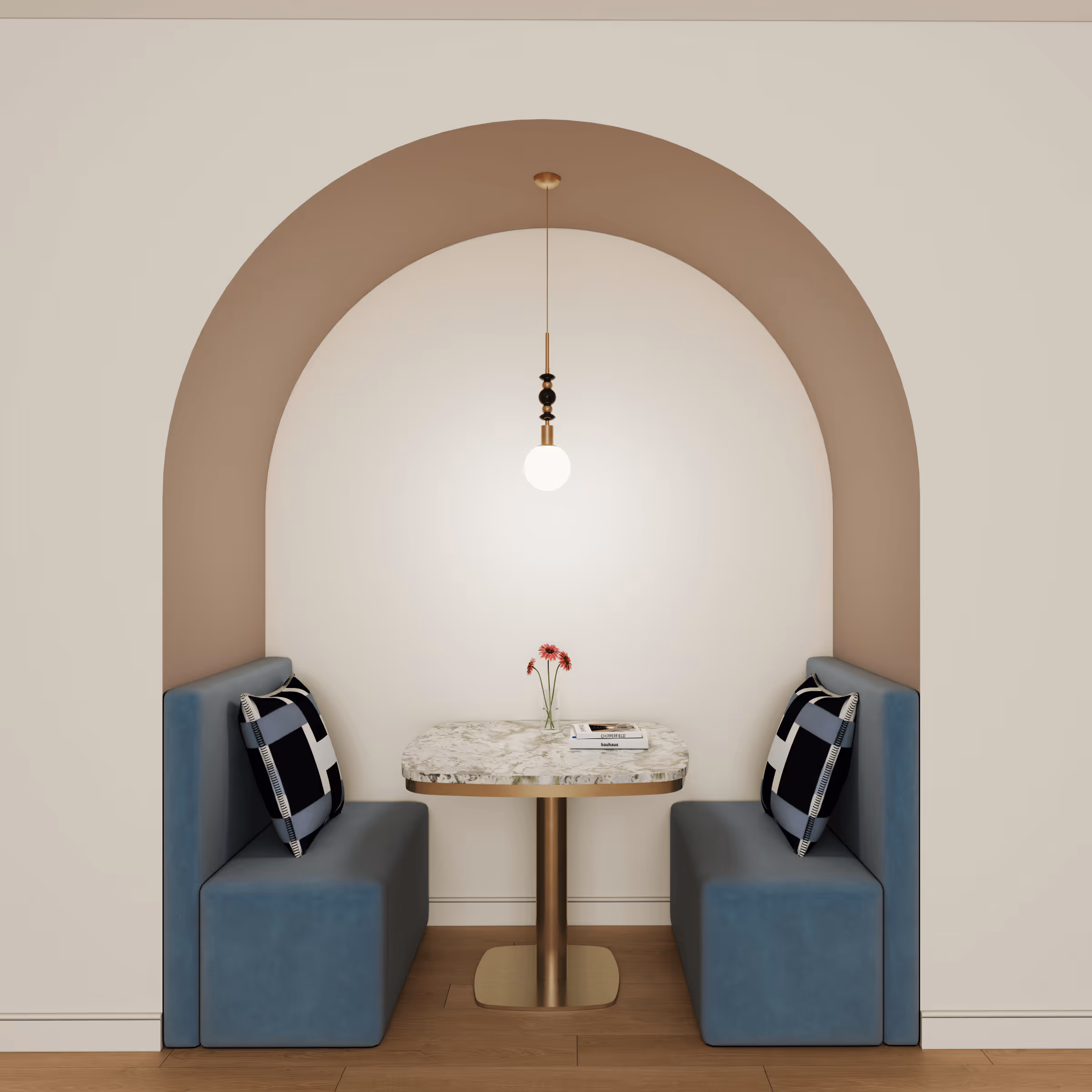 Cozy office nook with two blue upholstered bench seats facing a marble-top table under a pendant light and an arched wall niche.