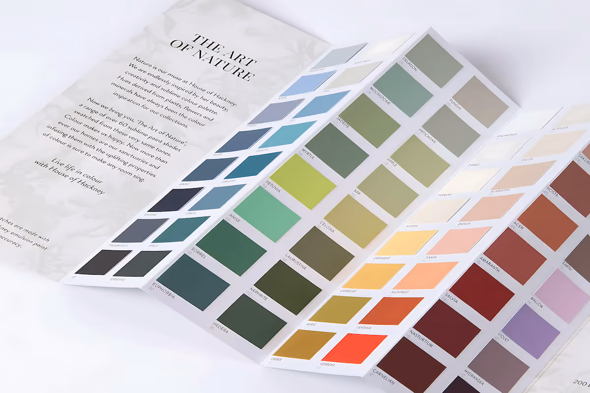 A folded color swatch booklet titled 'The Art of Nature' displaying over 60 paint shades ranging from blues and greens to yellows, oranges, reds, and purples.