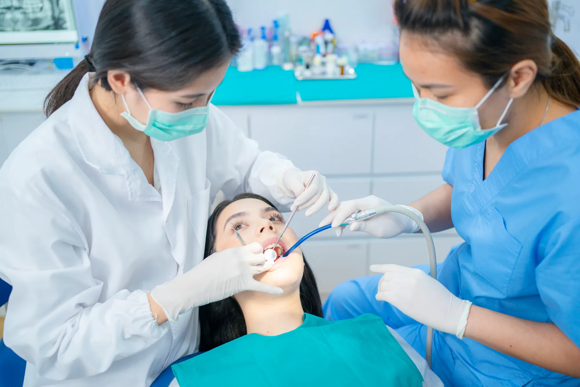 Woman undergoing dental sealants by reading dentists