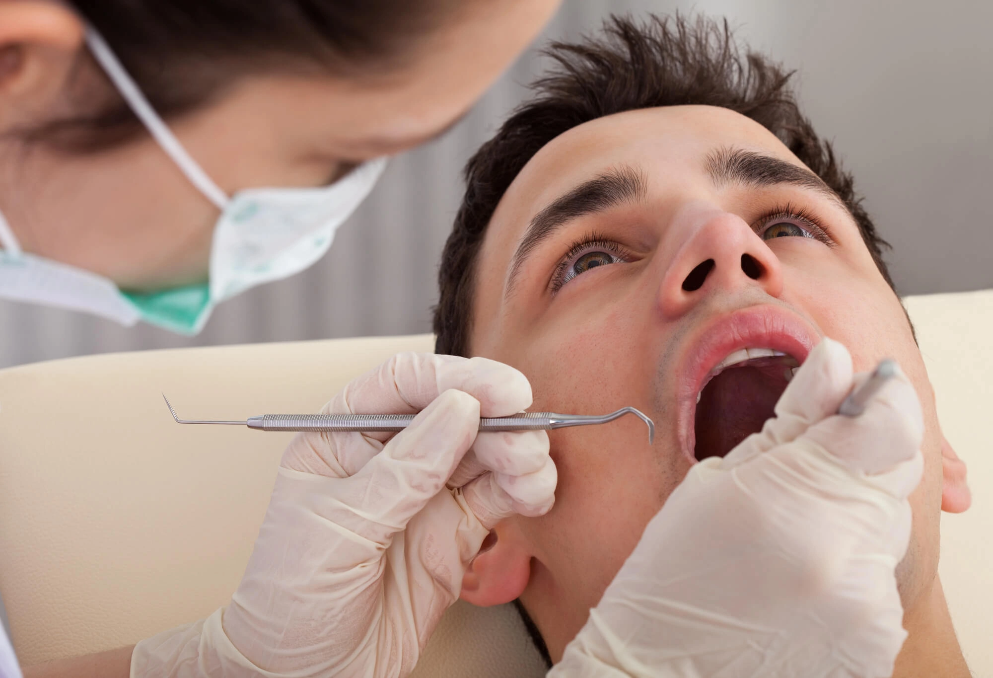 Man undergoing gum treatment by a periodontist reading pa