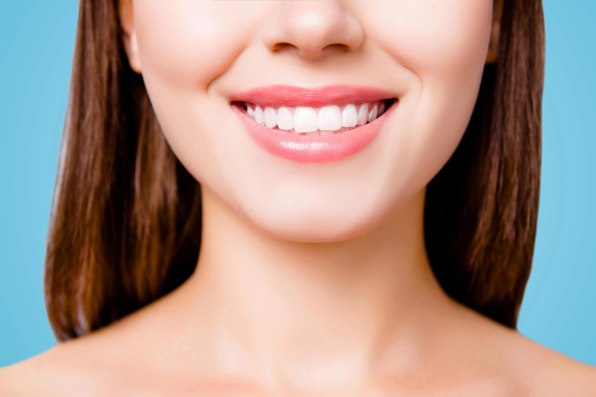 Woman smiling with dental implants reading pa