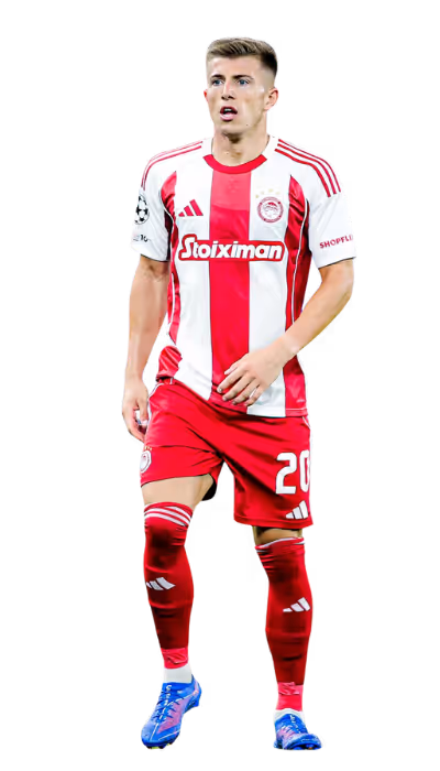 Soccer player in red and white striped jersey and red shorts walking, wearing blue cleats.