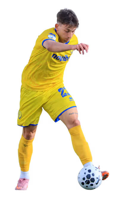 Soccer player in yellow kit controlling a black and white soccer ball.