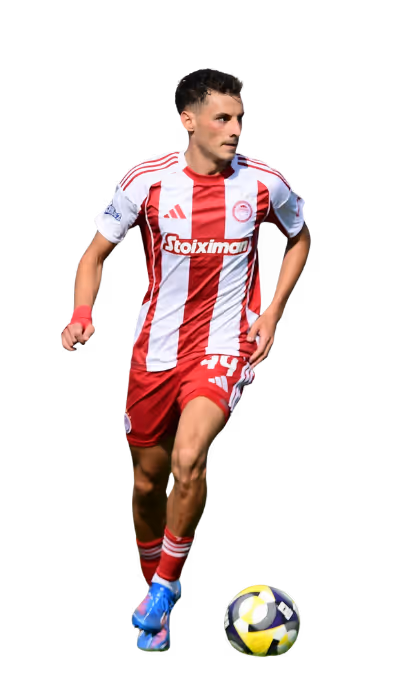 Soccer player in red and white striped uniform running with a soccer ball at his feet.
