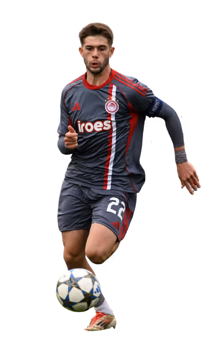 Soccer player in gray and red uniform dribbling a ball during a match.